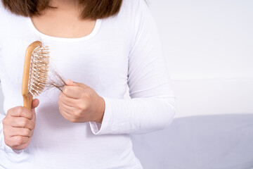 Hair fall problem, closeup hand holding comb and problem hair. Healthcare medical or daily life...