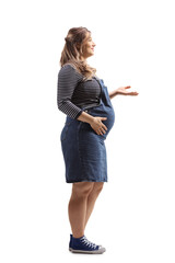 Full length profile shot of a young pregnant woman gesturing with hand