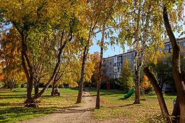 Two elderly women are sitting on a bench. Autumn landscape. Cityscape, view to the city of Yekaterinburg, Russia.