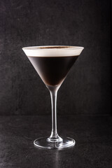Martini espresso cocktail in glass on black background