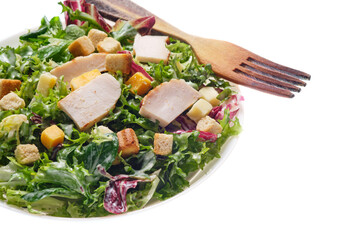 Plate of traditional Caesar salad with chicken and cheese