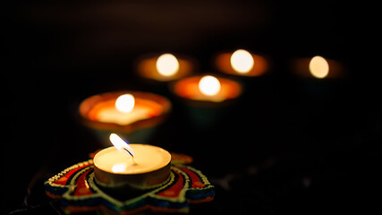 Happy Diwali day. Colorful traditional oil lamp diya on dark background.