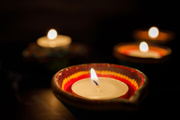 Happy Diwali day. Colorful traditional oil lamp diya on dark background.