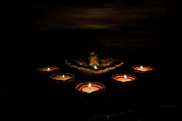 Happy Diwali day. Colorful traditional oil lamp diya on dark background.