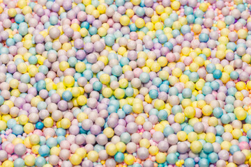 Purple, yellow, blue plastic balls.