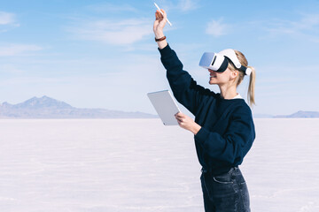 Happy lady enjoying virtual reality in salt flats