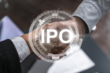Multiexposure of two businesspeople handshake and initial primary offering, IPO hologram drawing...