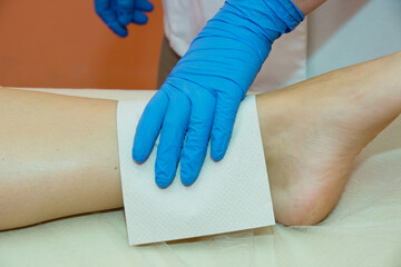 Laser hair removal procedure in a beauty salon. Removal of unwanted leg hair. Skin care procedure