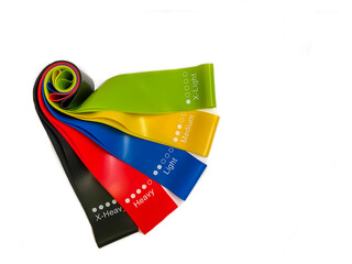 Set of colorful latex rubber bands for fitness on a white background.  sports concept.  fitness trend for home workouts. top view, flat lay, copy space, isolate.
