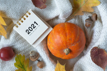 Calendar for 2021, pumpkin and warm cozy sweater, colorful leaves, hello autumn.