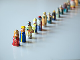 Row of figures of the Three Kings for the Christmas cake. White background and selective focus. Christmas concept.