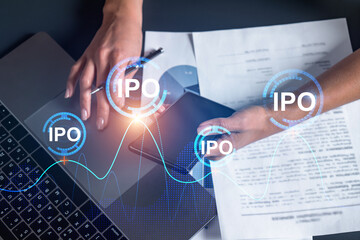 IPO hologram and a woman signing contract use phone. Double exposure. Initial primary offering concept.
