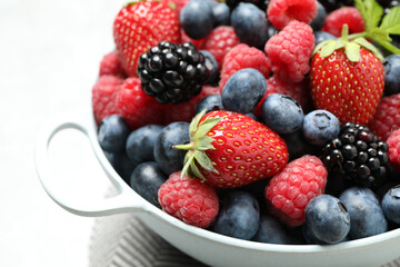 Mix of ripe berries in bowl, closeup