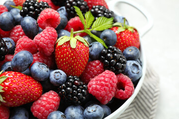 Mix of ripe berries in bowl, closeup