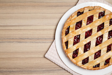 Delicious fresh cherry pie on wooden table, top view. Space for text