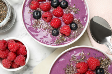Delicious acai smoothie with fruits served on white marble table, flat lay