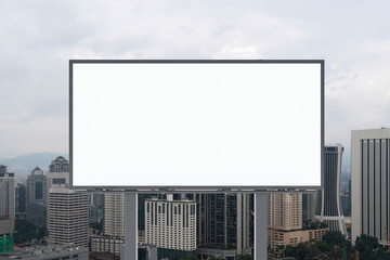 Blank white road billboard with KL cityscape background at day time. Street advertising poster, mock up, 3D rendering. Front view. The concept of marketing communication to promote or sell idea.