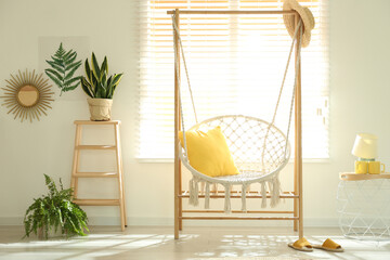 Comfortable hammock chair in stylish room. Home interior