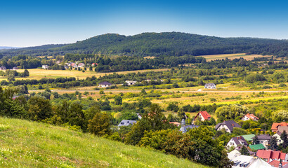 Fototapeta na wymiar Panoramic view of town Checiny in Swietokrzyskie Mountains seen from Royal Castle medieval fortress hill near Kielce in Poland