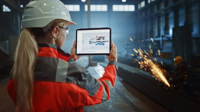 Professional Heavy Industry Engineer Uses Tablet Computer for Augmented Reality Render with Interactive Turbine Engine Blueprint