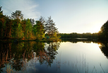 Fototapeta na wymiar Landscape with lake, forest, tent, reflection in the water, wildlife.