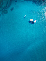 Top view over a yacht and a boat in a blue crystal clear waters of Mediterranean sea near Protaras, Cyprus 