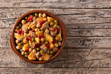 Ropa vieja food in bowl on rustic wooden table. Top view. Copy space