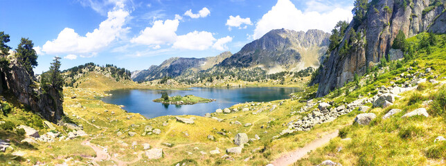 Panoramic view of a beautiful natural lake in the mountains. Llac del Circ de Colomers, Pirineus, Salardú, Naut Aran, Val d'Aran, Lleida, Catalonia, Spain. - obrazy, fototapety, plakaty