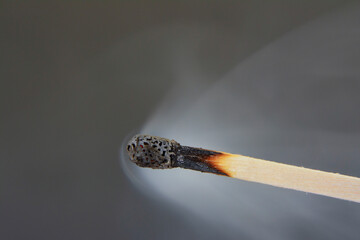 Extinguished phosphor pours smoke with gray background