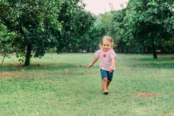 Toddler girl running in garden