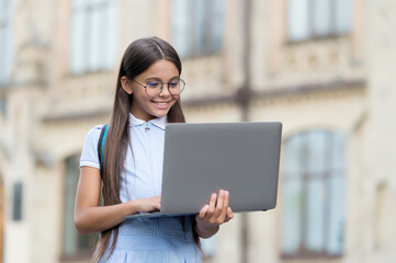future successful programmer. knowledge day. kid learning private lesson. childrens blogging. happy smiling girl with laptop. Start up. child playing computer game. back to school. education online