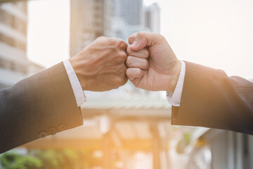 Business people shaking hands, hands bump, finishing up meeting. Deal Successful businessmen on public
