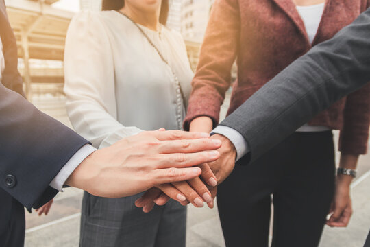 Business people shaking hands, putting their hands together, finishing up meeting. Deal Successful