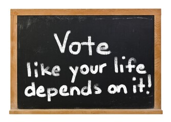 Obraz premium Vote like your life depends on it written in white chalk on a black chalkboard isolated on white