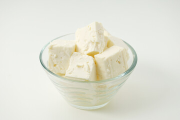 A glass bowl with sheep cheese	