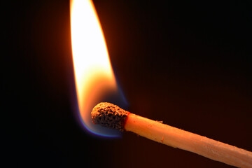 burning match on a black background