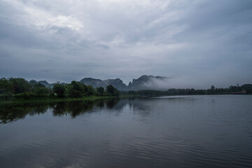 clouds over the lake against mountain background