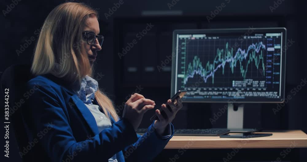Poster confident business woman in eyeglasses and suit using modern smartphone while sitting at own office.