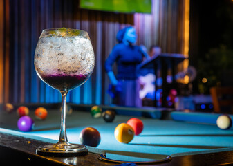 Soft focus and Closeup glass of cosmopolitan cocktail decorated with on the snooker table at bar...