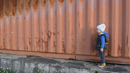a child near a shipping container