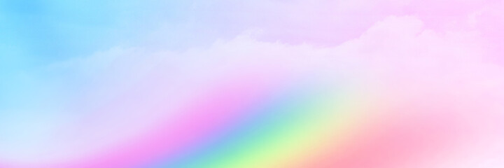 The Rainbow sky is Colorful sky with Soft clouds and a rainbow crossing. Fantasy magical sunny sky pastel background is fluffy white cloud. Freedom wallpaper concept. Sweet color dream.