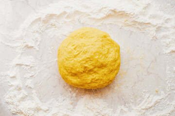 Fresh homemade yellow egg dough for pizza on the table