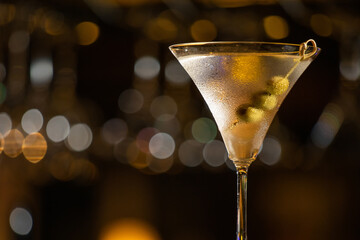 Soft focus and Closeup glass of cosmopolitan cocktail decorated with on the table at bar background.