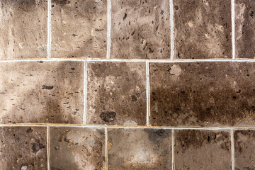 Naklejka premium Grey old stone pavement background, part of stone masonry