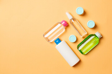 Cosmetics SPA branding mock-up, top view with copy space. set of tubes and jars of cream flat lay on colored background