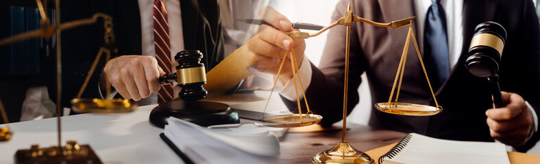 Business and lawyers discussing contract papers with brass scale on desk in office. Law, legal...