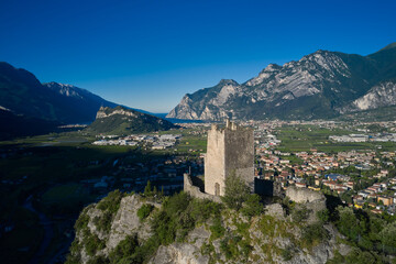 Fototapeta na wymiar Foundation of castle existed at least after the year 1000 AD. Arco Medieval Castle on the top of the rock. Arco Medieval castle, Trentino, Italy.