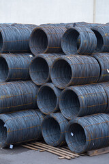 Steel low carbon wire rod, hot rolled steel drawing wire twelve millimeters or half an inch in diameter in coils. Freight transportation of heavy industry products by seaports. Export-import activity.