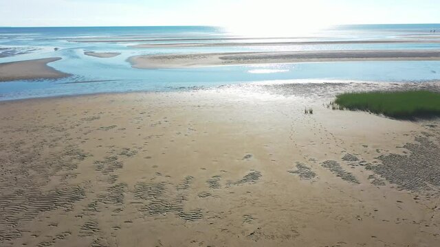 Beautiful Cape Cod Bay Aerial Drone Footage of Bay Side Beach at Low Tide with Sand Dunes Flying Towards Sun Over The Ocean, Reveal Shot