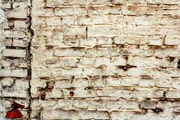 Texture of a brick wall with cracks and scratches which can be used as a background